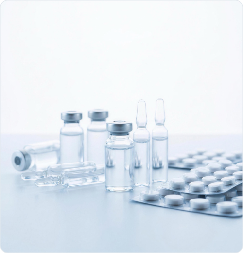 Pharmaceutical vials, ampoules and blister packs on a clean surface